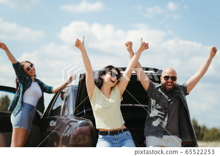 Three friends enjoying vacation travel by car Three friends enjoying vacation travel by car 65522253