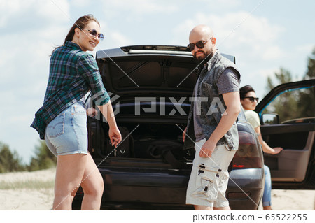 Three friends enjoying vacation travel by car Three friends enjoying vacation travel by car 65522255