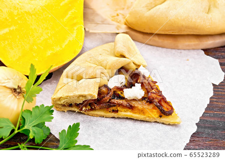 Pie with pumpkin and fried onions on wooden board Pie with pumpkin and fried onions on wooden board 65523289