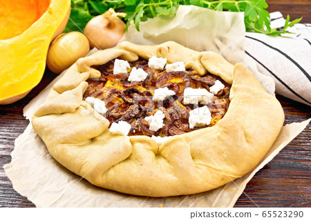 Pie with pumpkin and onions on board Pie with pumpkin and onions on board 65523290