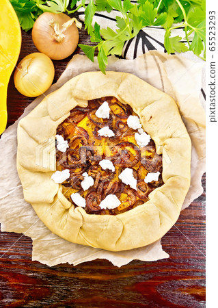 Pie with pumpkin and onions on wooden board top Pie with pumpkin and onions on wooden board top 65523293