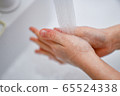Hand of a child to wash hands Hand of a child to wash hands 65524338