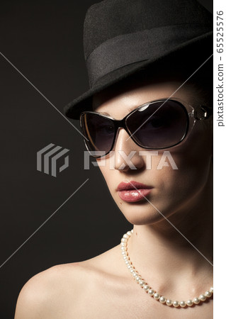 Portrait of Beautiful young woman in black hat and Portrait of Beautiful young woman in black hat and 65525576