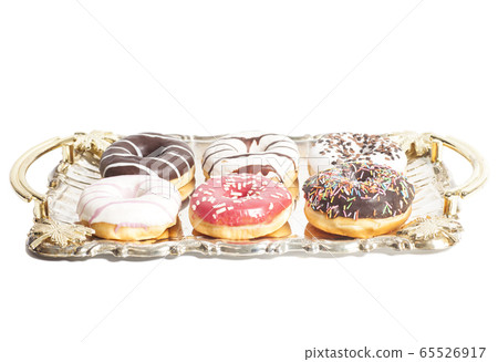 Group of doughnuts on the tray on white background Group of doughnuts on the tray on white background 65526917