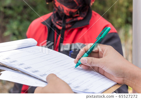 Delivery service female hands holding pen signing delivery document. Delivery service female hands holding pen signing delivery document. 65527272