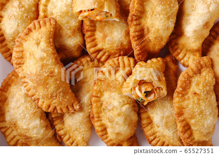 deep fried empanadas on a white paper deep fried empanadas on a white paper 65527351