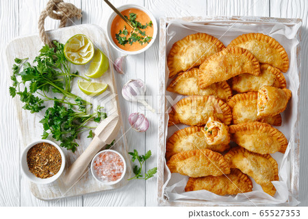 deep fried empanadas in a wooden box 65527353