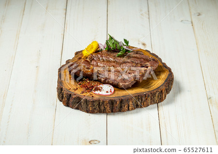 Roasted grilled beef meat steak on wooden board 65527611