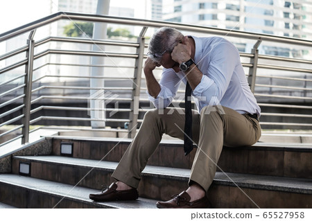 Fired sad businessman due to covid-19 65527958