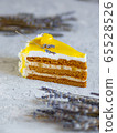 A piece of delicious cream cake. Tasty dessert. Over light wooden background. 65528526