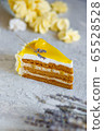 A piece of delicious cream cake. Tasty dessert. Over light wooden background. 65528528