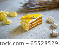 A piece of delicious cream cake. Tasty dessert. Over light wooden background. 65528529