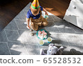 Little child is playing with birthday cakes 65528532
