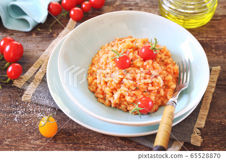 Italian cuisine. Plate of tomato risotto, olive and cherry tomatoes  65528870