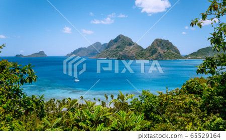 El Nido, Palawan, Philippines. Yacht boat in the sea bay near Las Cabanas beach. Rocky mountains in background 65529164