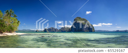 Palawan, Philippines. Tropical panorama view of El Nido coastline with huge rocky island on the background. National Marine Park 65529167