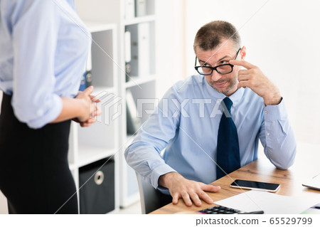 Lustful Businessman Staring At Young Coworker Lady In Modern Office Lustful Businessman Staring At Young Coworker Lady In Modern Office 65529799