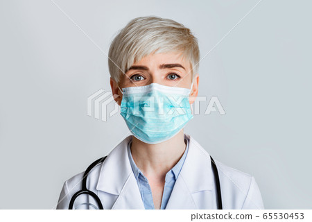 Health and medicine concept. Portrait of friendly therapist in protective mask, close up 65530453