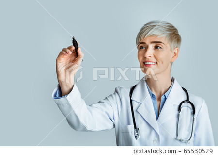 Diagnostics concept. Woman doctor write with marker on virtual board Diagnostics concept. Woman doctor write with marker on virtual board 65530529