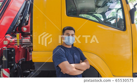 Truck drivers wearing medical masks 65530575