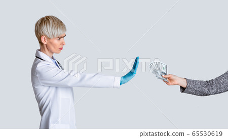 Bribe concept. Strict doctor dont takes money of patient Bribe concept. Strict doctor dont takes money of patient 65530619