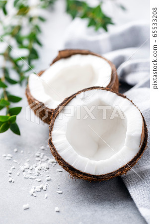Coconut halves on concrete background 65533208