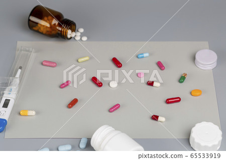 Home treatment. Digital thermometer, different pill bottles, tablets,capsules Home treatment. Digital thermometer, different pill bottles, tablets,capsules 65533919