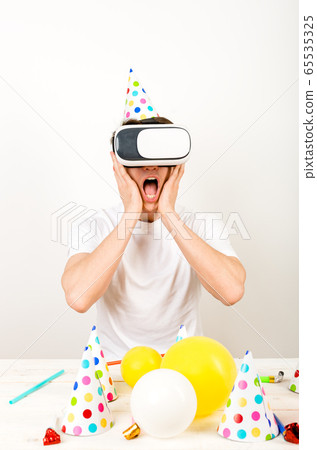 Verticled frame - a man wearing 3d glasses sitting Verticled frame - a man wearing 3d glasses sitting 65535325