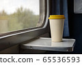 A bamboo coffee cup with a yellow silicon lid  65536593
