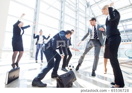Business team playing soccer 65536728