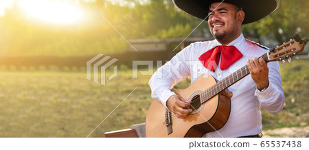 Mexican musician play in the city. City street in the summer. Mexican musician play in the city. City street in the summer. 65537438