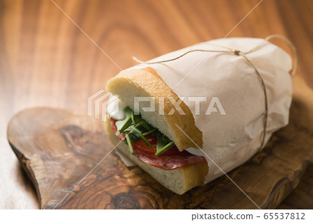 ciabatta sandwich with salami and mozzarella cheese on walnut table ciabatta sandwich with salami and mozzarella cheese on walnut table 65537812