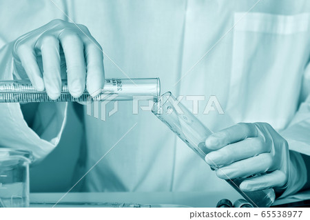 Scientists researching in laboratory, Chemist holding scientific glassware equipment 65538977