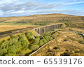 A drone shot of The Ribblehead Viaduct a Grade II listed structure, the Viaduct runs the Settle to Carlisle railway route in North Yorkshire, England. 65539176
