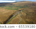 A drone shot of The Ribblehead Viaduct a Grade II listed structure, the Viaduct runs the Settle to Carlisle railway route in North Yorkshire, England. 65539180