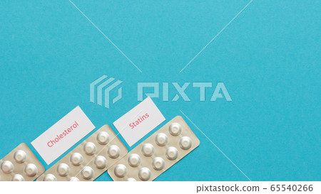 Statin tablets on a blue background Statin tablets on a blue background 65540266