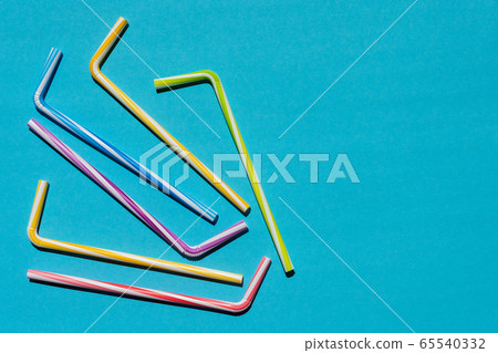 Striped tubules for drinks on a blue background Striped tubules for drinks on a blue background 65540332