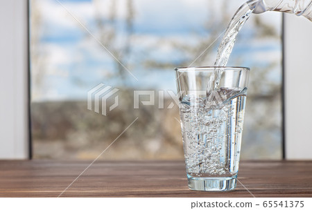 water pouring from jug into glass water pouring from jug into glass 65541375
