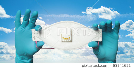 Protective mask in hands in doctor gloves on sky 65541631