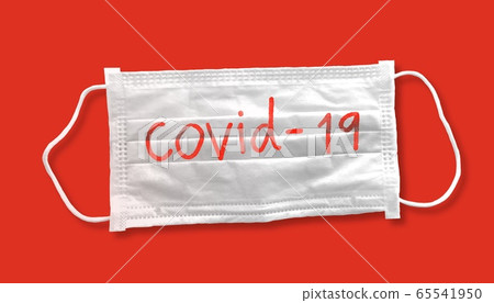 Medical mask for corona or covid-19 virus with covid-19 text ,safety  masks for virus inflection,isolated on orange background , health protection concept,cover to prevent virus,pollution 65541950