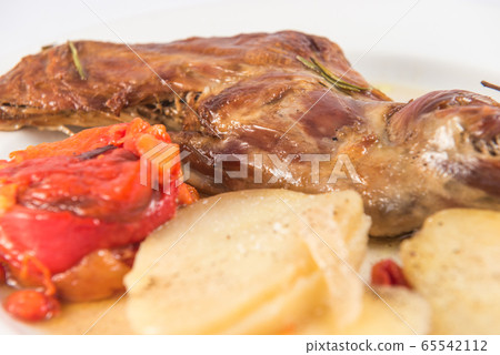 Baked leg of goat, with baked potatoes and roasted red peppers. Baked leg of goat, with baked potatoes and roasted red peppers. 65542112