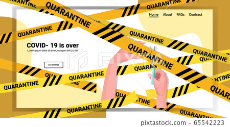 human hand holding scissors and cutting yellow tape coronavirus quarantine is over human hand holding scissors and cutting yellow tape coronavirus quarantine is over 65542223