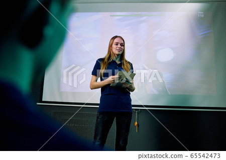 Young confident female developer of new network video game with tablet 65542473