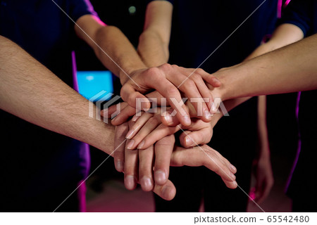 Pile of hands of young contemporary successful cybersports video gamers 65542480