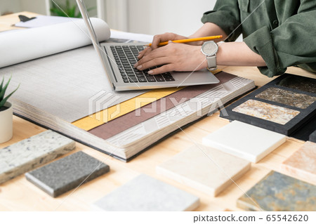 Hands of contemporary designer of interior touching buttons of laptop keypad Hands of contemporary designer of interior touching buttons of laptop keypad 65542620