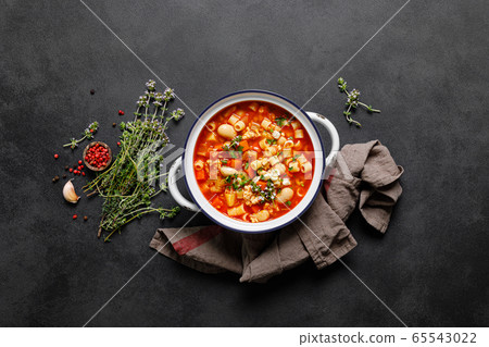 Cooking pasta e fagioli soup with chicken meat and 65543022