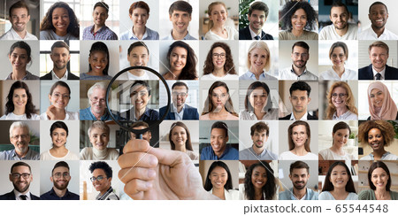 Hr manager holding magnifier choosing indian recruit among multiethnic faces 65544548