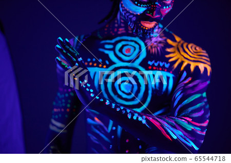 young man blur with ultraviolet body art 65544718