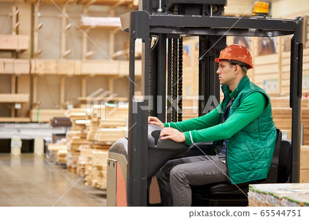 warehouse worker sit inside of machine warehouse worker sit inside of machine 65544751