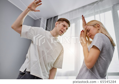 angry cruel man doesn't love his wife, beats her angry cruel man doesn't love his wife, beats her 65545284